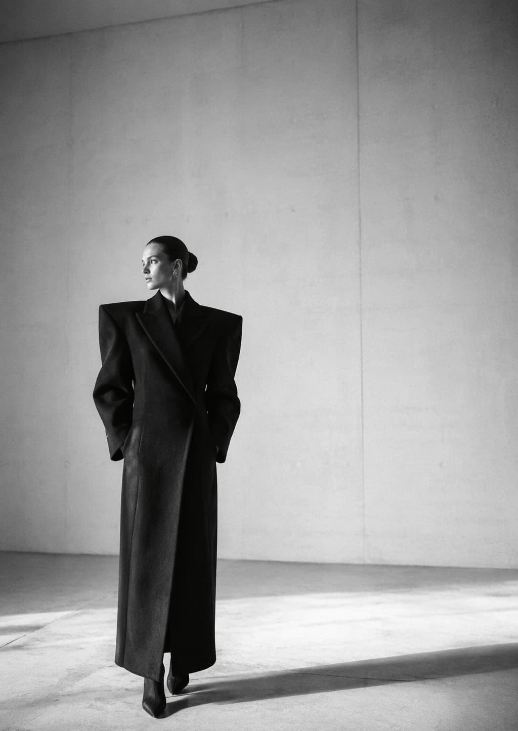 Editorial — sculptural dark tailored coat, studio study